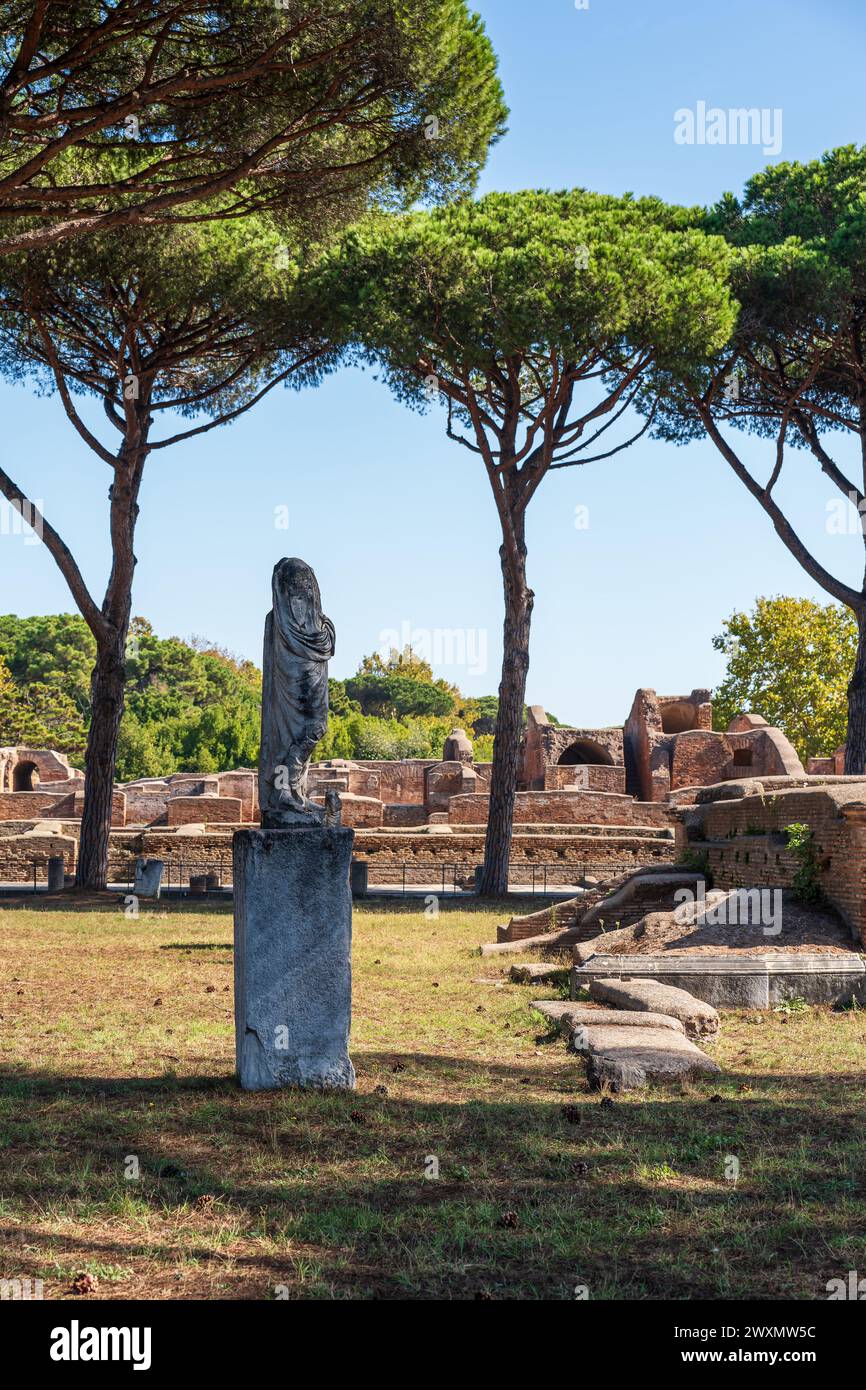 Rovine di statue ed edifici nel parco archeologico dell'antica Ostia Foto Stock