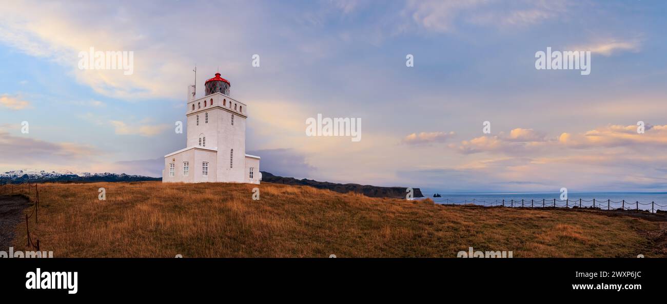 Pittoresca vista serale autunnale del faro di Dyrholaey e della spiaggia di sabbia vulcanica nera dell'oceano di Reynisfjara a far, Vik, Islanda meridionale. La gente non riconosce Foto Stock