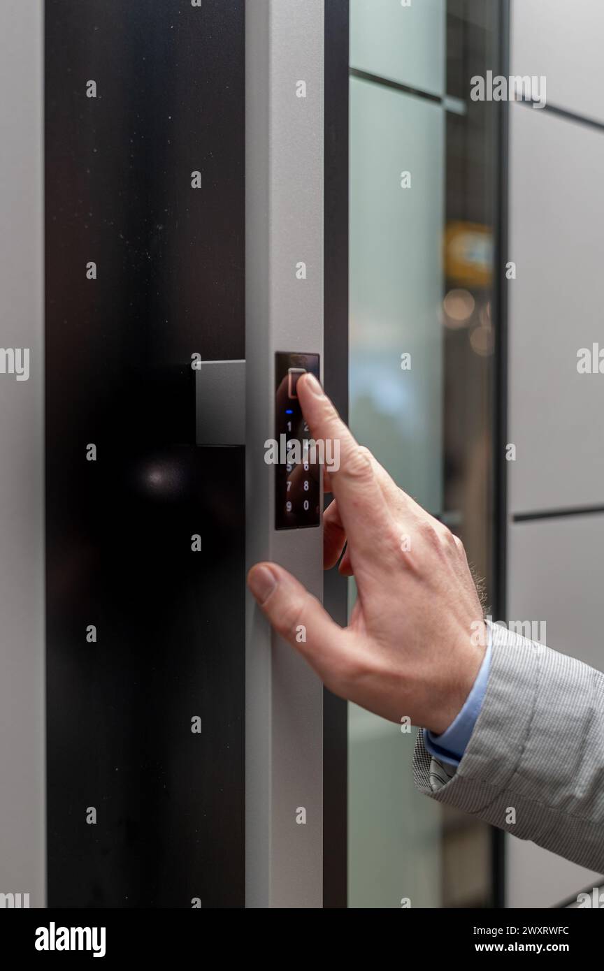 Uno scatto di primo piano verticale di una persona che usa una porta elettronica per entrare in un appartamento Foto Stock