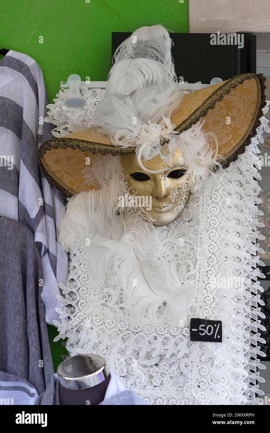 Costume da carnevale veneziano di fronte a un negozio, Burano, Veneto, Italia Foto Stock