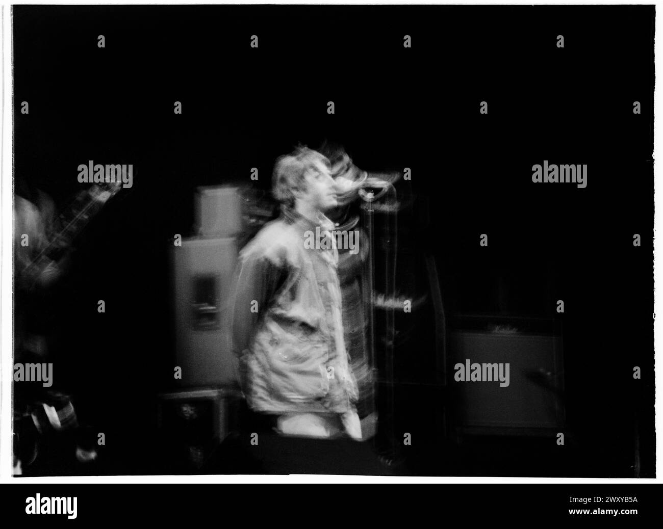 OASIS, FIRST GLASTONBURY HEADLINE, 1995: Liam Gallagher in a long exposure Photograph headliner the Main Stage al culmine della loro fama al Glastonbury Festival, Pilton Farm, Somerset, Inghilterra, 24 giugno 1995. Nel 1995 il festival ha celebrato il suo 25 ° anniversario. Non c'era una fase piramidale quell'anno, dato che era bruciata. Foto: ROB WATKINS Foto Stock