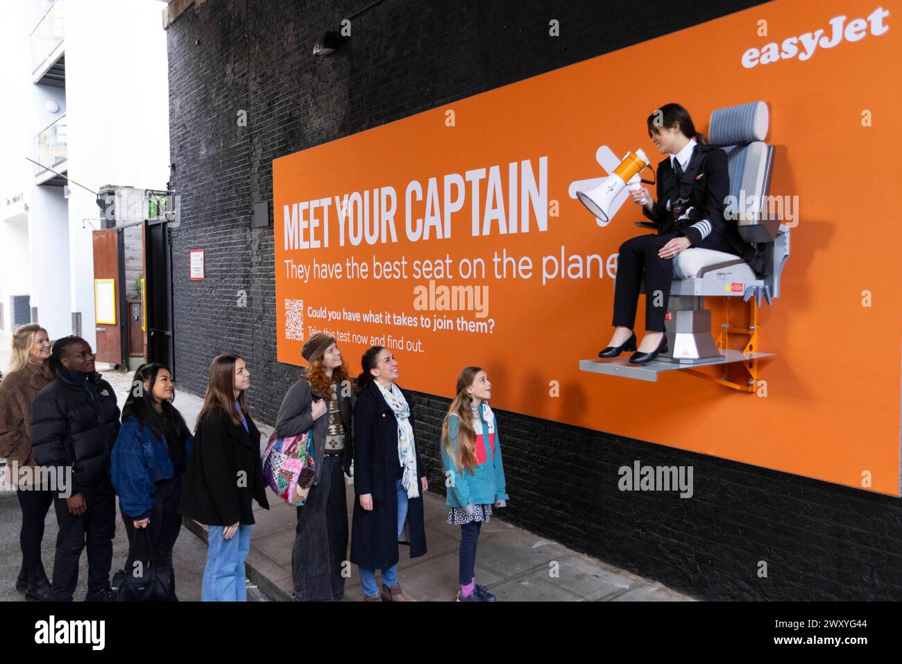 SOLO Sarah Ackerley, pilota easyJet, siede su un cartellone interattivo a Londra, al lancio di una nuova campagna di reclutamento da parte della compagnia aerea, "cartelloni pubblicitari", che sfida le persone a fare un nuovo test attitudinale. Data foto: Mercoledì 3 aprile 2024. Foto Stock