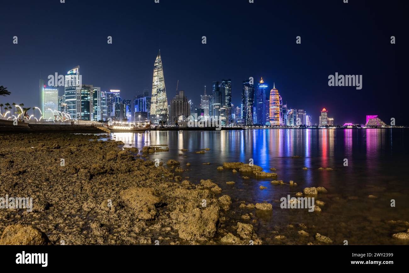 Skyline notturno della città di Doha illuminato di notte. Qatar, Medio Oriente, penisola arabica Foto Stock
