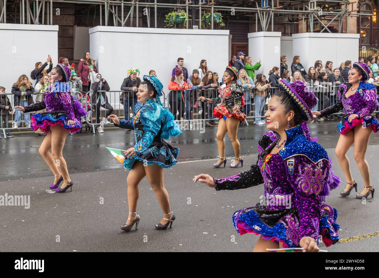 Ballerini boliviani in costumi dai colori vivaci che partecipano alla processione della sfilata del giorno di San Patrizio a Londra. Foto Stock