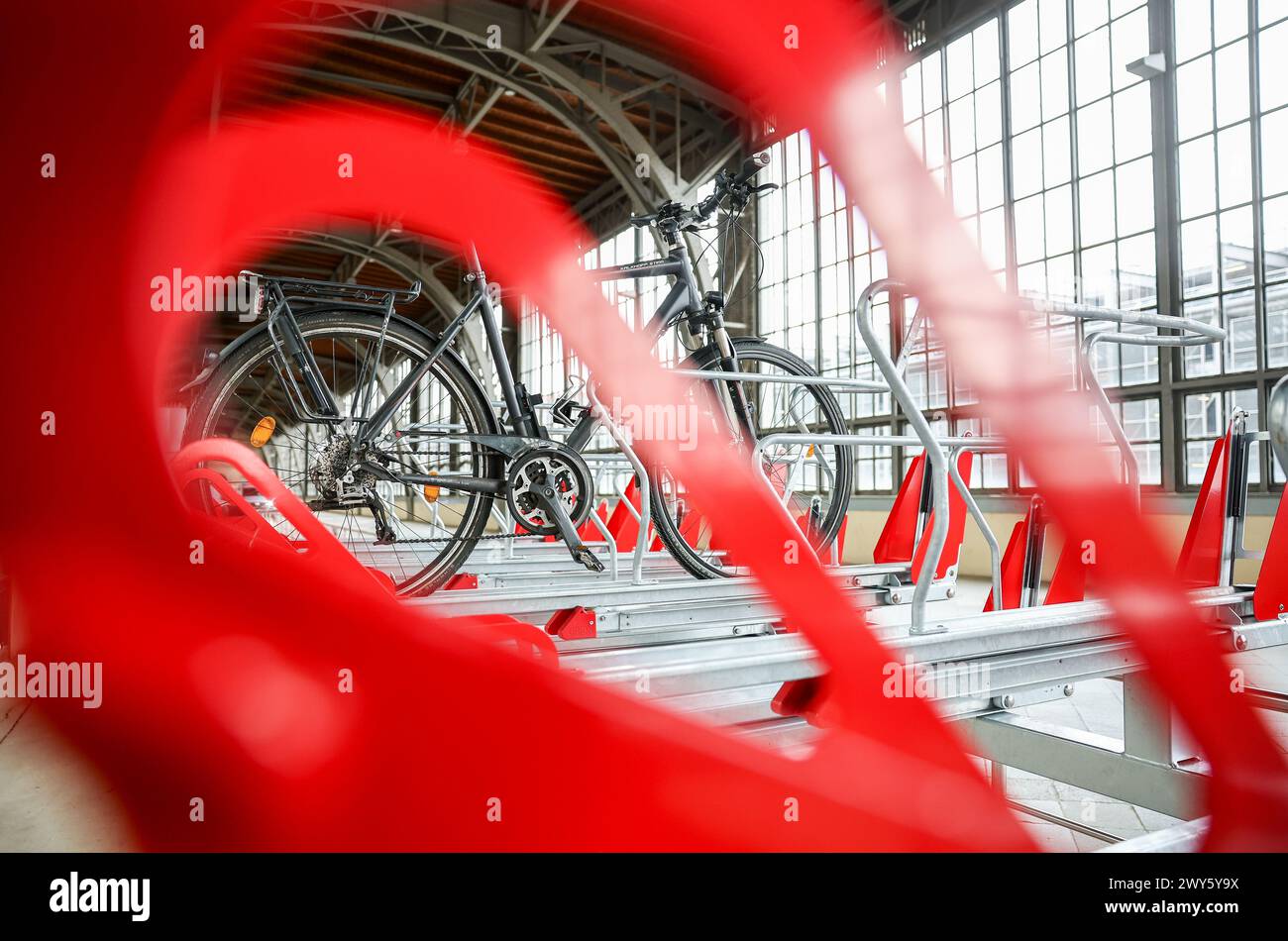 4 aprile 2024, Sassonia, Lipsia: Una prima bicicletta viene parcheggiata nei nuovi posti auto per biciclette della stazione centrale di Lipsia. Nell'area dell'ex binario 1 sul lato ovest della stazione sono stati costruiti i cosiddetti parcheggi a due piani per biciclette. 174 biciclette possono essere parcheggiate gratuitamente su due livelli. La nuova struttura ha un costo totale di 75.000 euro ed è stata finanziata come parte della campagna Bike+Ride da Deutsche Bahn e dal Ministero federale dell'economia e della protezione del clima (BMWK). Foto: Jan Woitas/dpa/ZB Foto Stock