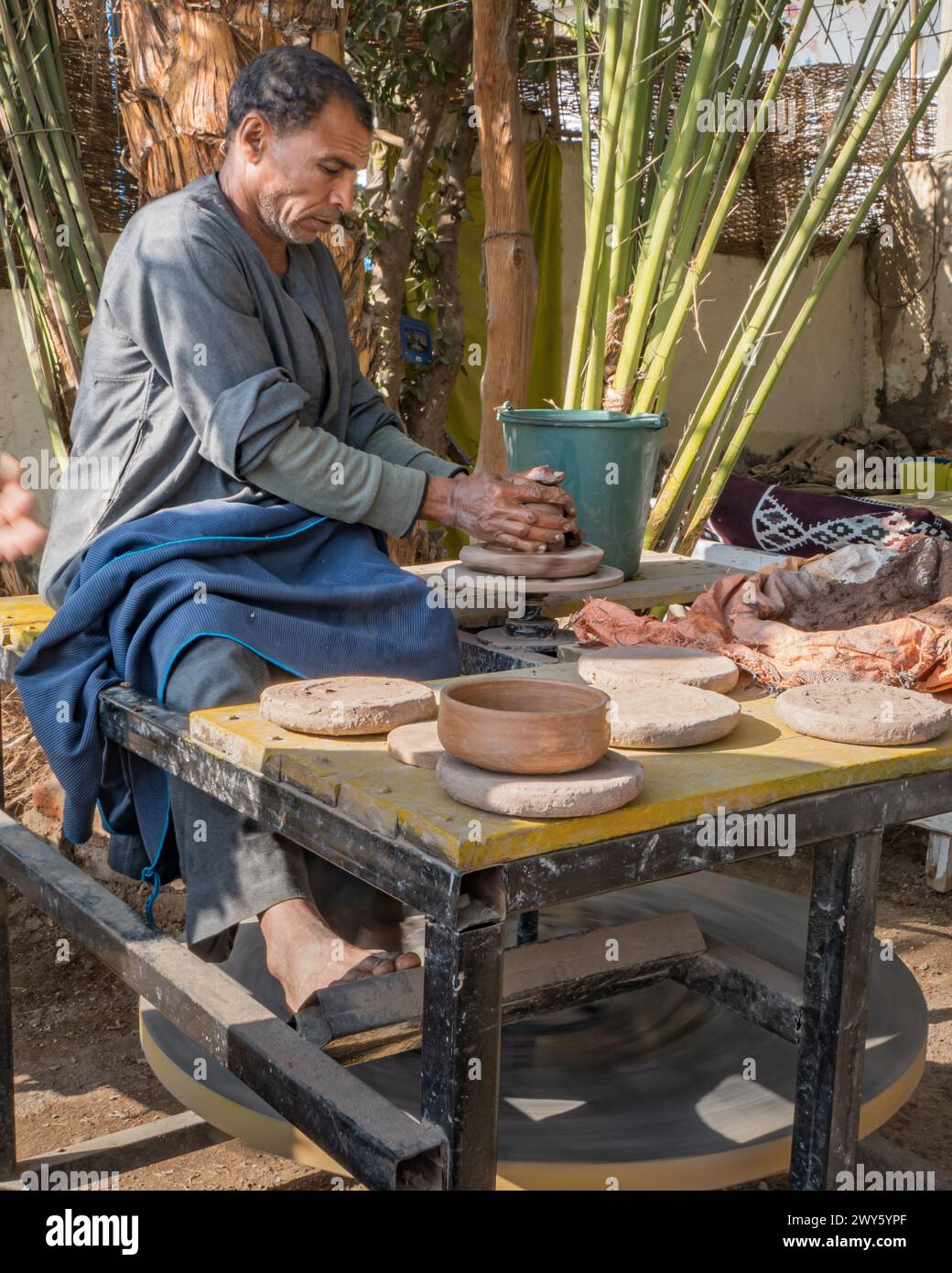 Riva orientale del Nilo, Luxor, Egitto - 30 dicembre 2023: vasaio del villaggio che lancia ciotole di argilla per l'uso Foto Stock