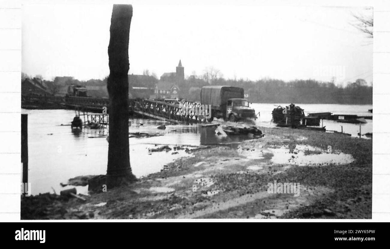 THE MAAS IN FLOOD VICINO a MAESEYK - Vista generale delle inondazioni e del ponte, e i veicoli di rifornimento possono essere visti spruzzare attraverso l'acqua mentre rotolano dal ponte. , British Army, 21st Army Group Foto Stock