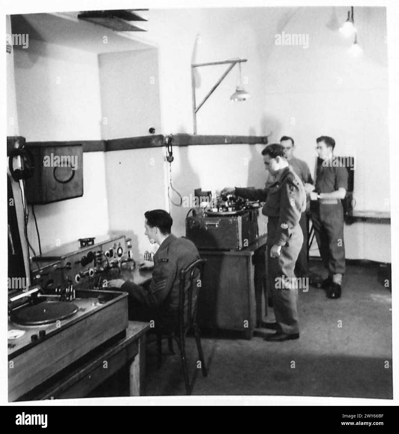Il sergente Jack Sheard di REME a Manchester sta registrando dischi su un registratore Telefunken catturato per le trasmissioni delle forze britanniche ad Amburgo. I record presentano scanalature che scorrono dall'interno verso l'esterno per una migliore qualità e una sostituzione più semplice. Circa il dieci per cento delle apparecchiature di Broadcasting House viene utilizzato, con microfoni di alta qualità. Sheard si allenò con il radar, costruì un furgone e registrò concerti in tutta la zona britannica. Foto Stock