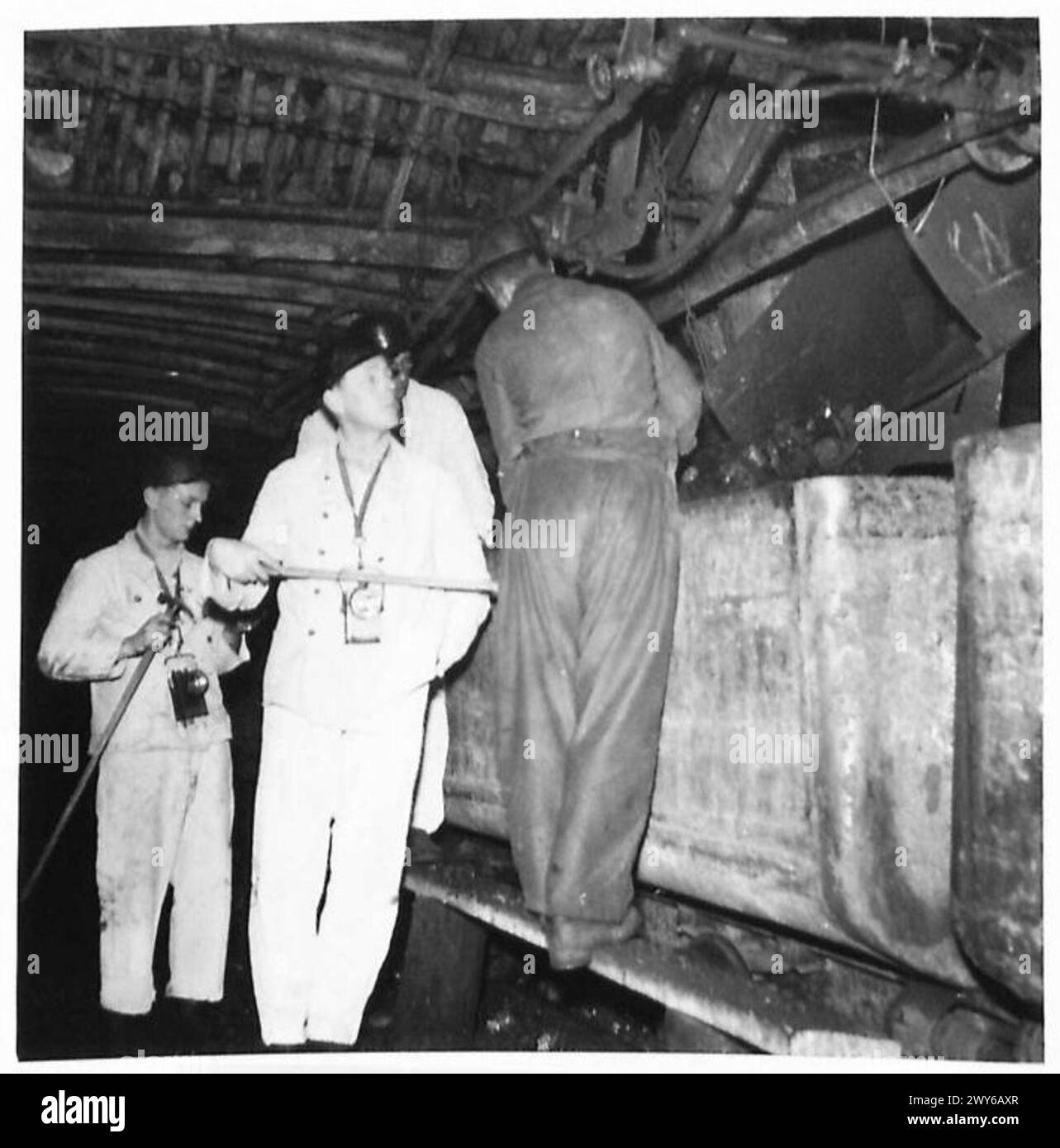 Il maggiore F.R. Salmon, ex direttore della miniera e ingegnere minerario, parla con un minatore su un nastro trasportatore alla fossa come nuovo direttore di produzione per un distretto della Ruhr, sotto l'esercito britannico del Reno. Foto Stock