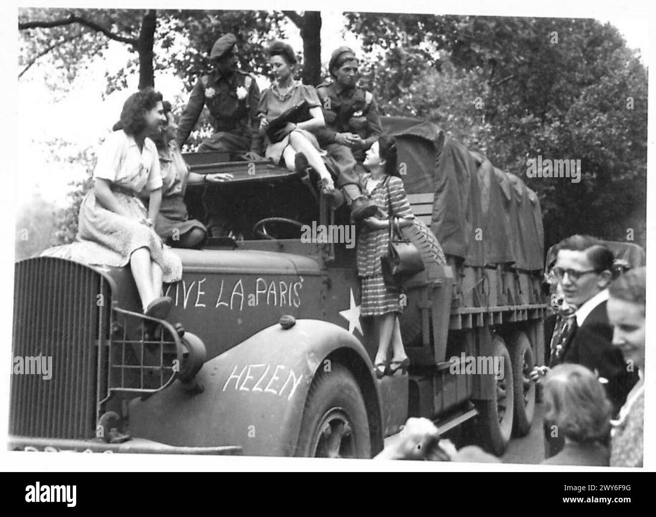 CIBO PER PARIGI - i parigini felici si arrampicano su camion del cibo ben carichi che fanno amicizia con gli uomini che hanno portato il cibo. , British Army, 21st Army Group Foto Stock