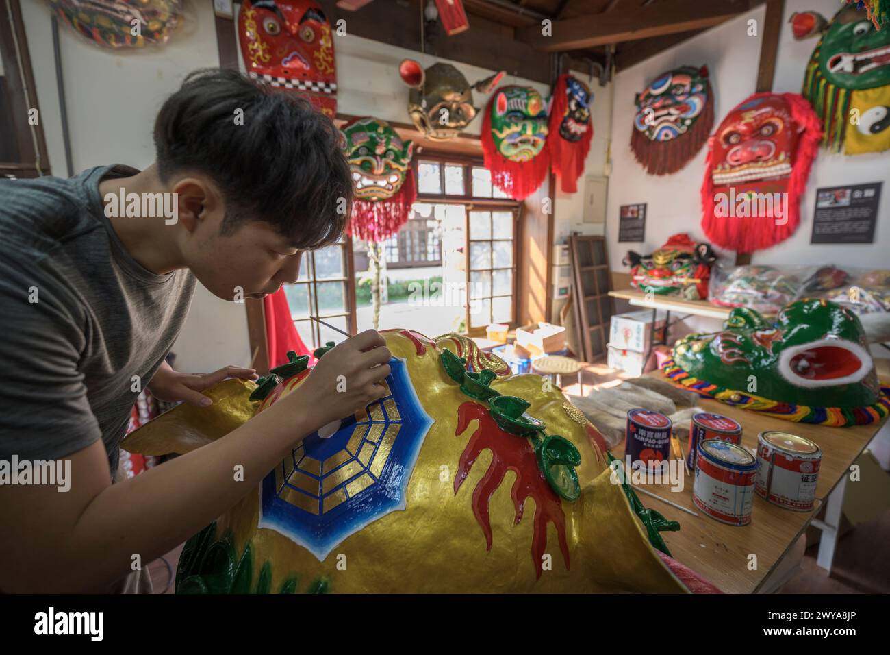 Primo piano di un dipinto artigianale disegni elaborati su una brillante scultura di drago dorato Foto Stock