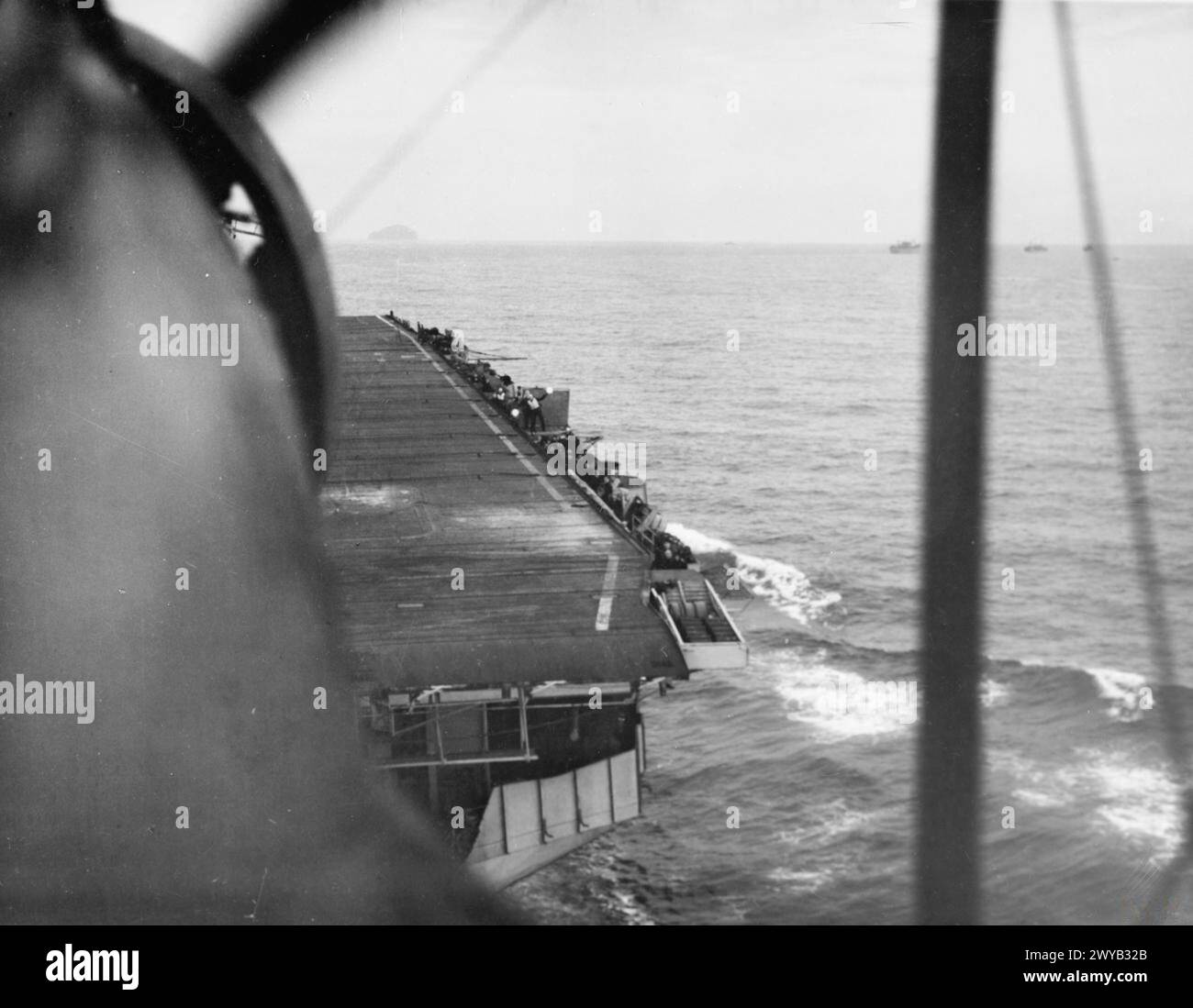 CON LA PORTAEREI DI SCORTA HMS SMITER. 1944, IN MARE, A BORDO DI UN PESCE SPADA FAIREY DELLA PORTAEREI DURANTE L’ADDESTRAMENTO DEGLI UFFICIALI DI CONTROLLO DELL’ATTERRAGGIO IN COPERTA, QUANDO GLI AEROMOBILI DECOLLAVANO E ATTERRAVANO. - Guardando in basso lo SMITER come un Fairey Swordfish e' entrato a terra. , Foto Stock