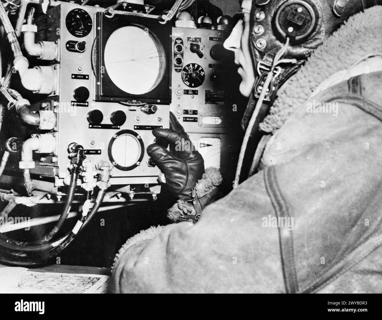 Un navigatore aziona il sistema radar H2S su un bombardiere Lancaster intorno al 1944, utilizzando il Plan Position Indicator (PPI) del tubo catodico e i comandi per la navigazione e il targeting. Foto Stock