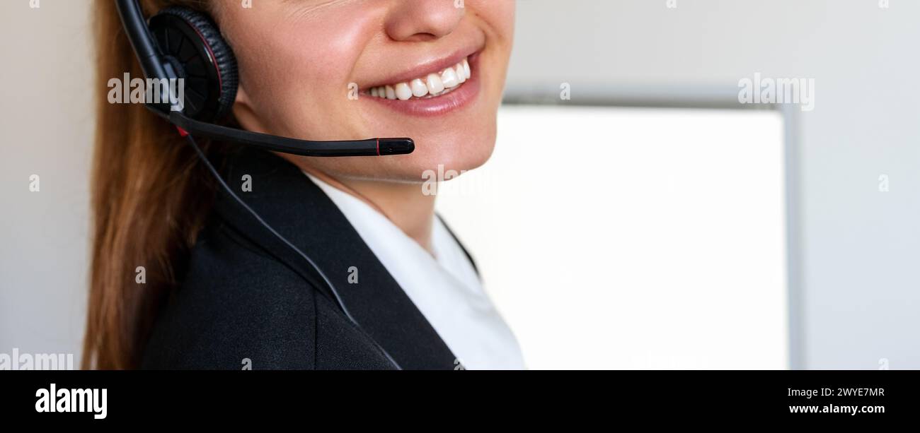 Primo piano del sorriso di una donna del call center. Agente online del servizio clienti. Servizio di assistenza telefonica. Foto Stock