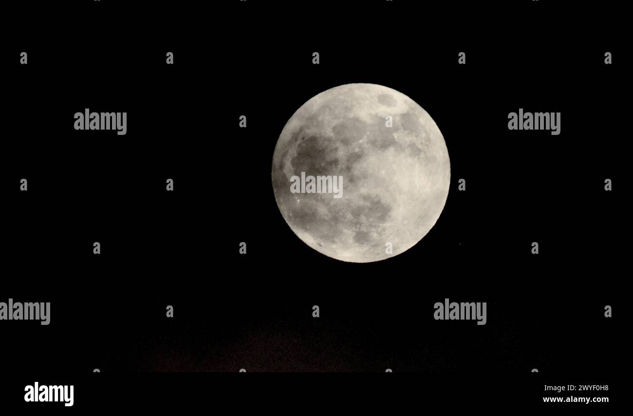 Magnifica luna piena in alta definizione: Un ritratto chiaro e dettagliato del satellite naturale della Terra che illumina l'oscurità del cielo notturno Foto Stock