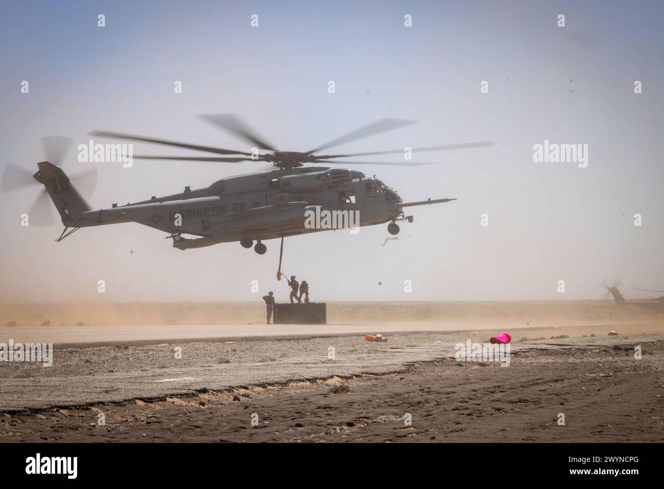 Un elicottero CH-53E Super Stallion del corpo dei Marine degli Stati Uniti, assegnato al Marine Aviation Weapons and Tactics Squadron One, si prepara a sollevare una cassa durante un esercizio di sollevamento esterno come parte del corso Weapons and Tactics Instructor 2-24, presso l'Auxiliary Airfield II, vicino a Yuma, Arizona, 29 marzo 2024. WTI è un corso avanzato di livello laureato che fornisce un addestramento tattico avanzato per migliorare e utilizzare armi e tattiche di aviazione avanzate. (Foto del corpo dei Marines degli Stati Uniti di Gabriela Garcia-Gregorio) Foto Stock