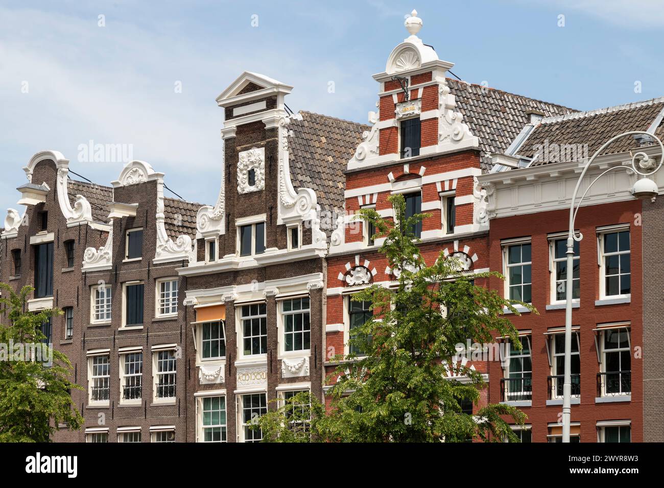 Le facciate storiche delle case sul canale lungo il Rokin ad Amsterdam. Foto Stock