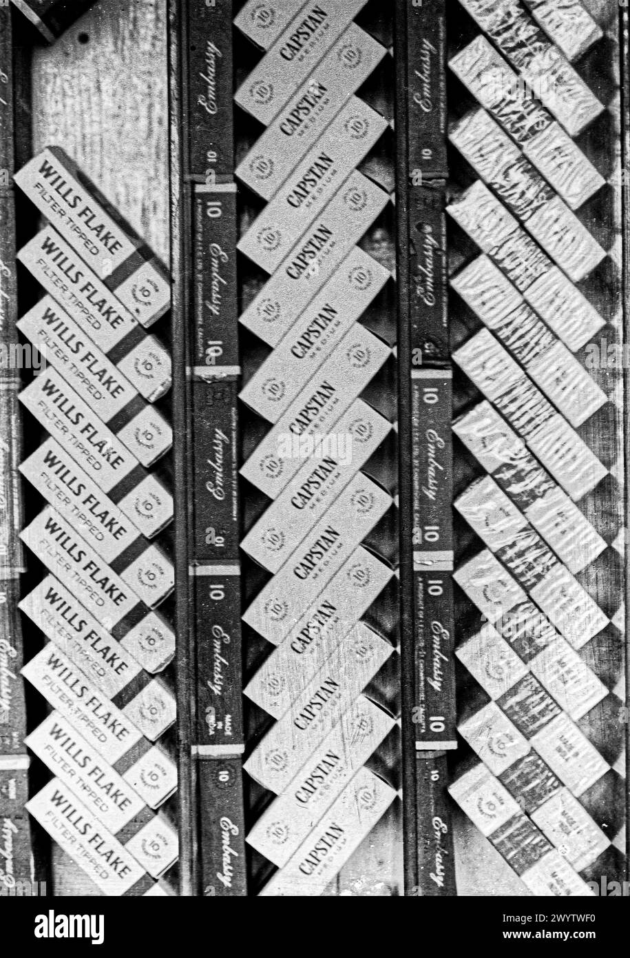 Vintage Old Black and White Photo of Tobacconist display of Cigarette Packets Hyderabad Telangana India Asia. Foto Stock