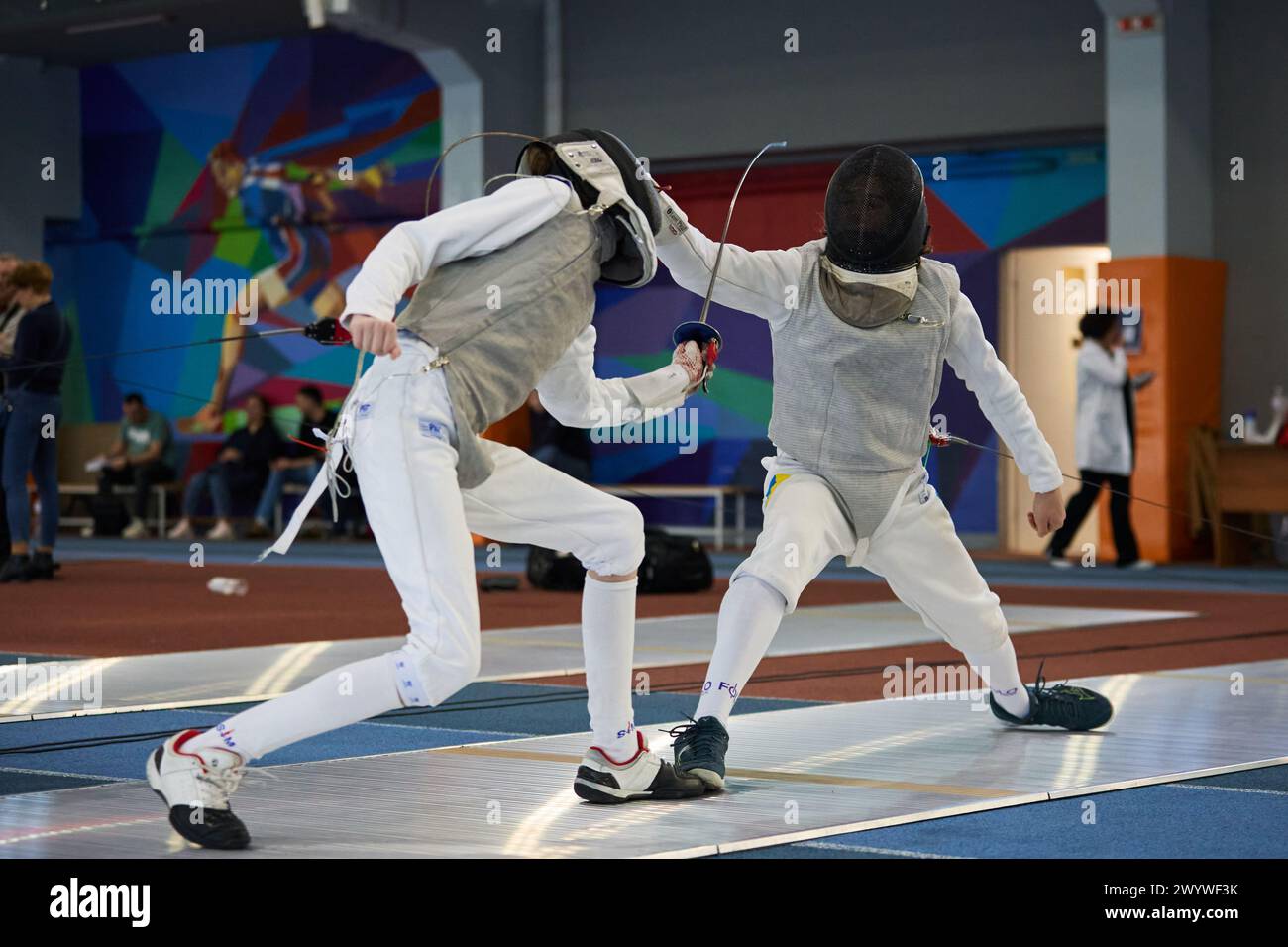 Schermitori che combattono in pista in un'arena sportiva durante il Campionato nazionale di scherma dell'Ucraina. Kiev - 30 marzo 2024 Foto Stock