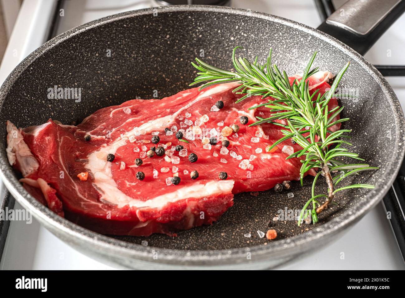 Bistecca di manzo in una padella sul piano cottura, cucinando alla perfezione Foto Stock