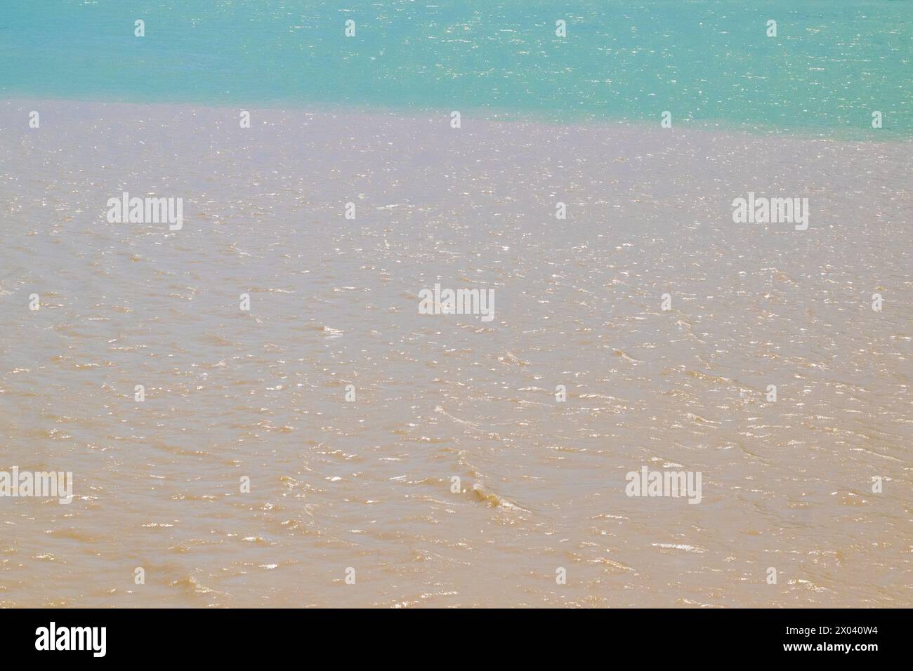 Due fiumi di colori diversi si fondono in uno. Diversa consistenza e colore dell'acqua. Foto Stock