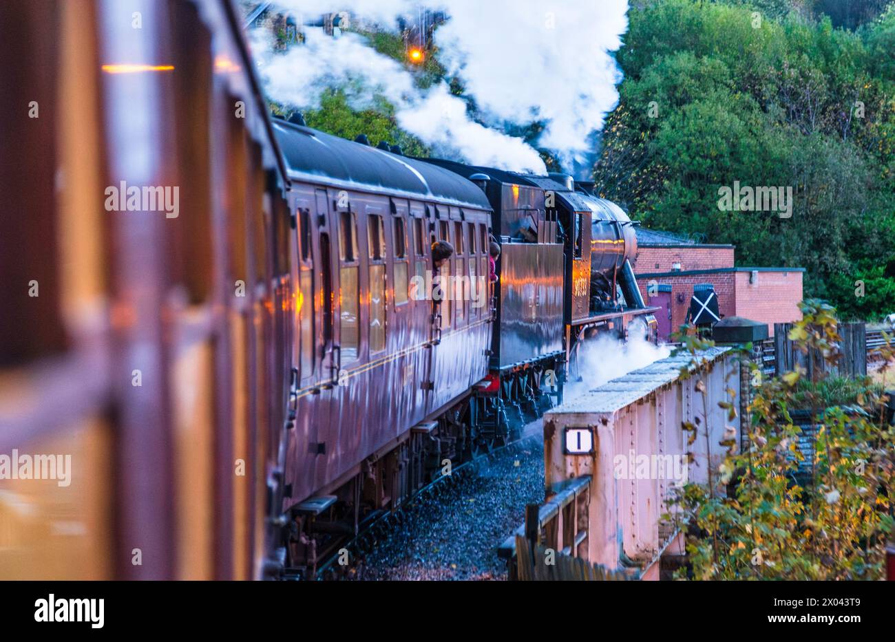 Treno passeggeri trainato da locomotiva a vapore che parte dalla stazione di Keighley sulla Keighley and Worth Valley Railway, Yorkshire, Inghilterra. Foto Stock