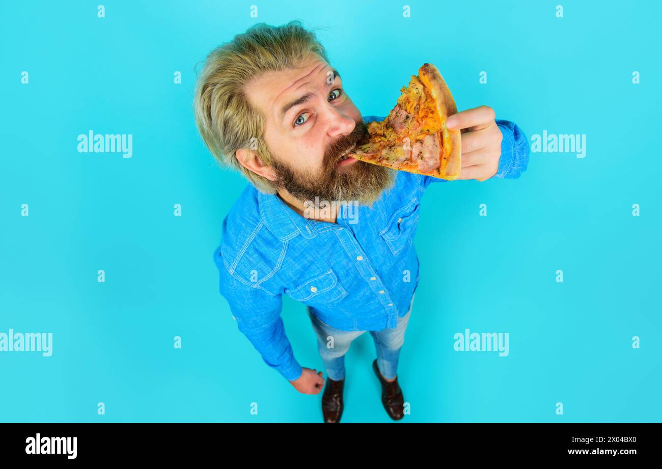 Tempo della pizza. Uomo barbuto in camicia di jeans che mangia fetta di pizza. Fast food. Cucina italiana. Gustosa pizza alla pizzeria o al ristorante. Pranzo o. Foto Stock