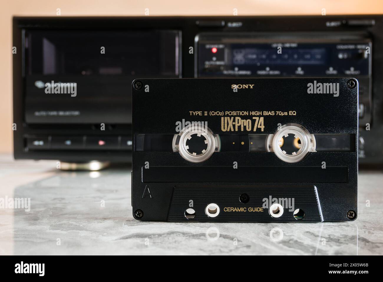 L'audiocassetta Sony UX-PRO 74 si trova di fronte a un deck su un piano in marmo lucido con riflessi Foto Stock