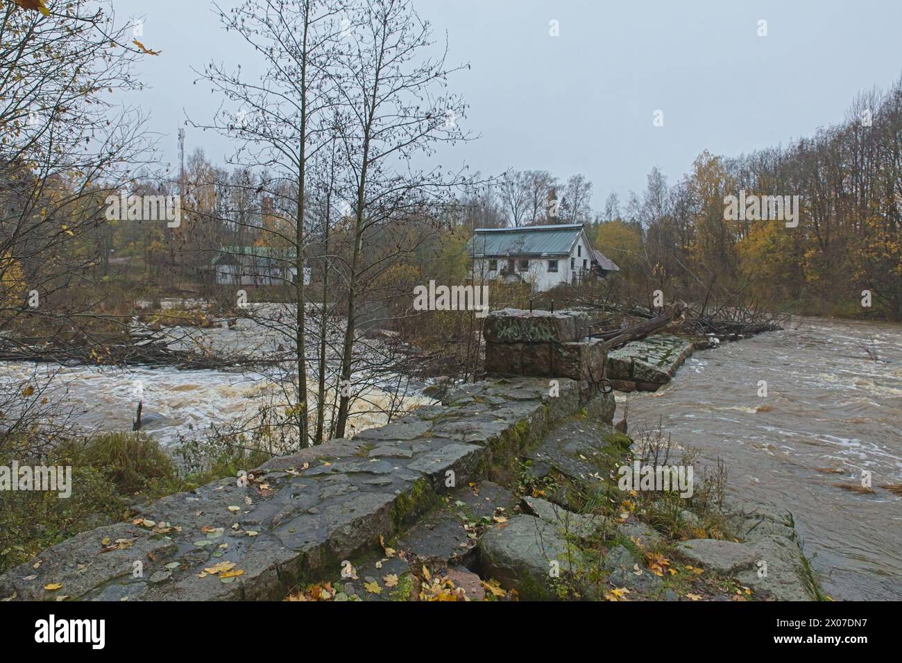 Vecchia diga di Vantaankoski fatta di pietra sul fiume Vantaanjoki in un clima autunnale nuvoloso, Vantaa, Finlandia. Foto Stock