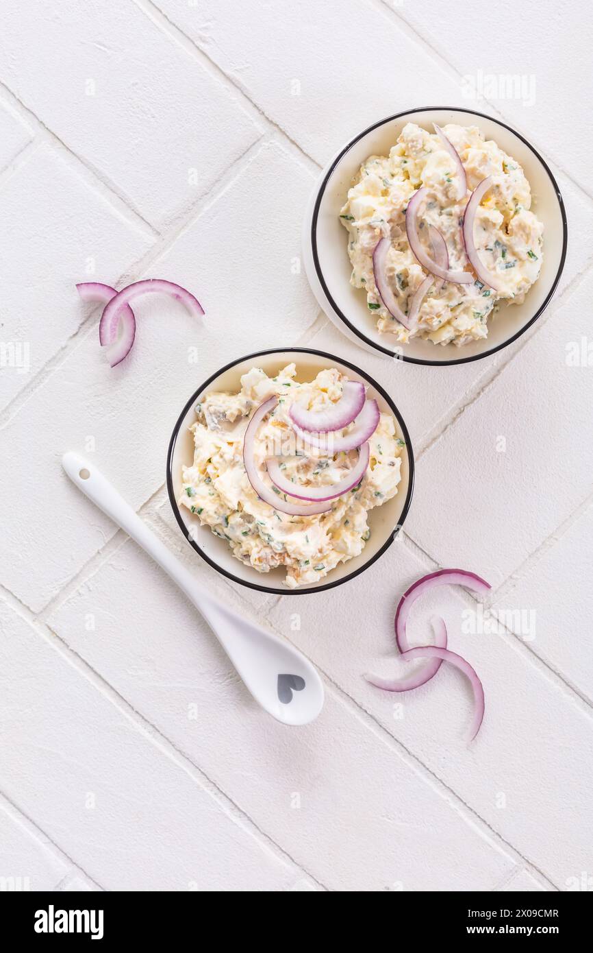 Spalmare pesce e uova, pasta o insalata con cipolle rosse Foto Stock