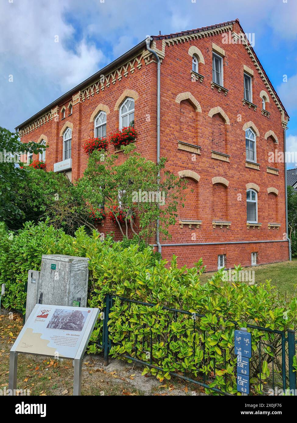 Un cartello informativo in primo piano descrive la storia della vecchia farmacia nella località di villeggiatura e nella località balneare baltica di Prerow, Fischland Darß, Meclemburgo-Vorpommern, Germania Foto Stock
