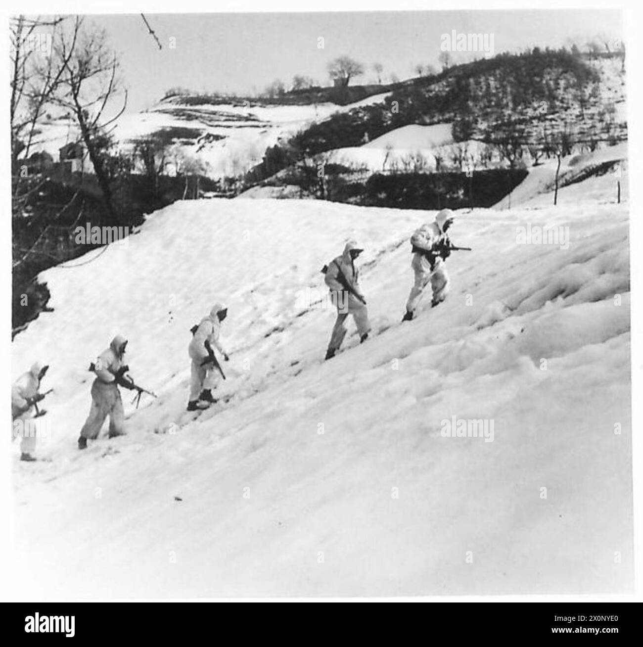 Una pattuglia dell'esercito britannico raggiunge un piccolo aumento, usando la sua copertura per muoversi con maggiore libertà durante le operazioni in Italia. Negativo fotografico, British Army. Foto Stock