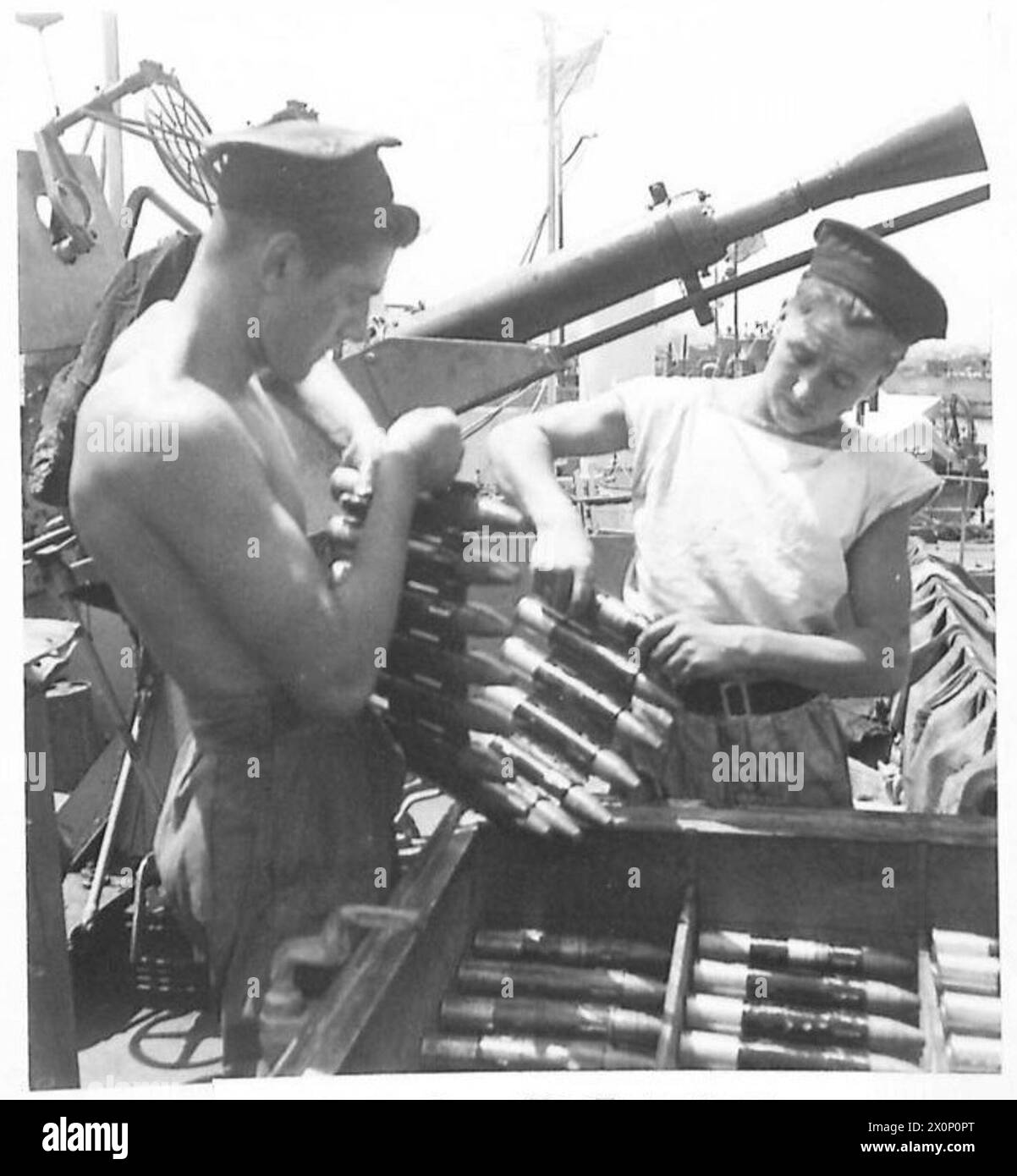I cannoni antiaerei su carri armati da sbarco (L.C.T.S) caricano clip di munizioni durante i preparativi per l'invasione a Tripoli, fotografati dall'esercito britannico. Foto Stock