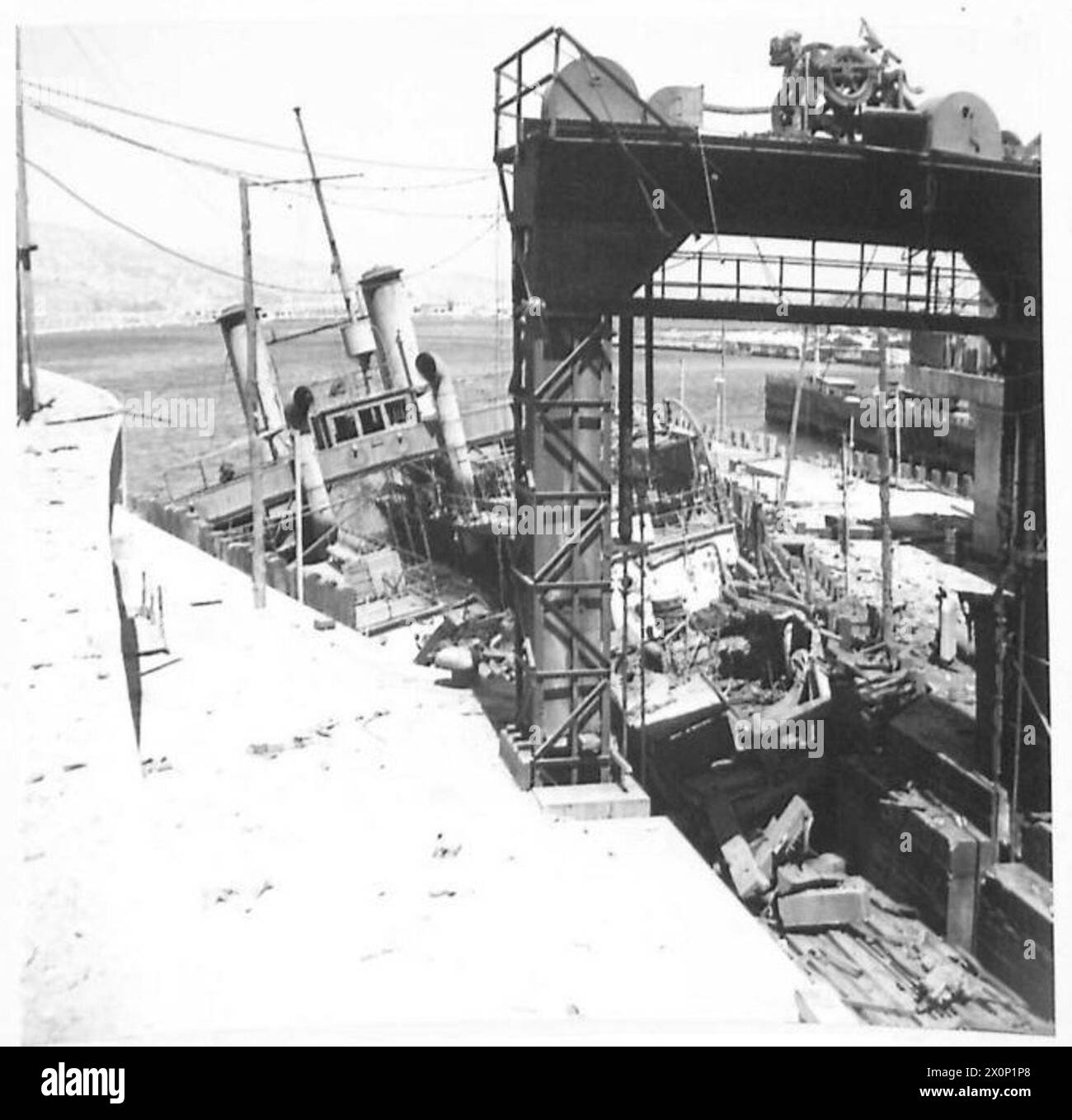 Un traghetto affondato è visto allo stadio di atterraggio quando l'VIII Armata entra a Messina. Negativo fotografico, British Army. Foto Stock