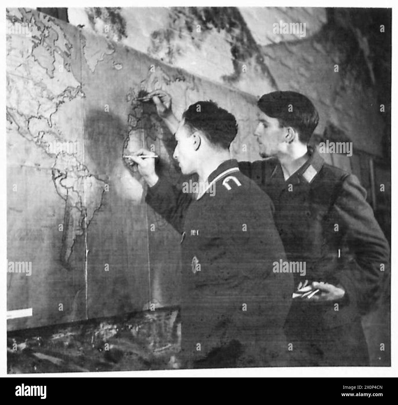 Due aviatori tedeschi in un campo di prigionia di guerra sono impegnati nella creazione di mappe. Foto Stock