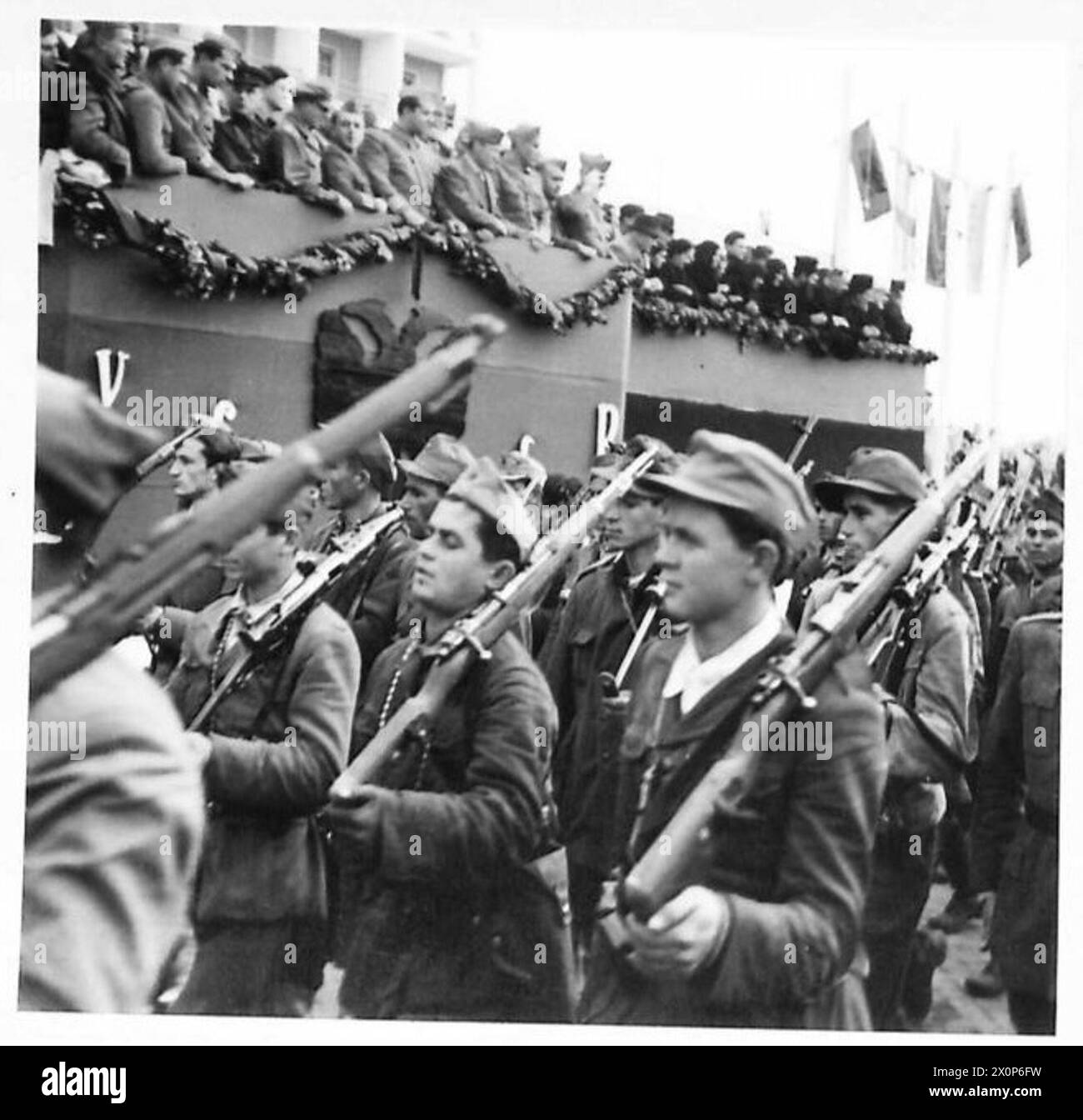 GIORNATA DELL'INDIPENDENZA IN ALBANIA - le truppe partigiane del 1° corpo marciano oltre la base salutista durante la parata del giorno dell'indipendenza a Tiana, la capitale dell'Albania. Negativo fotografico, British Army Foto Stock