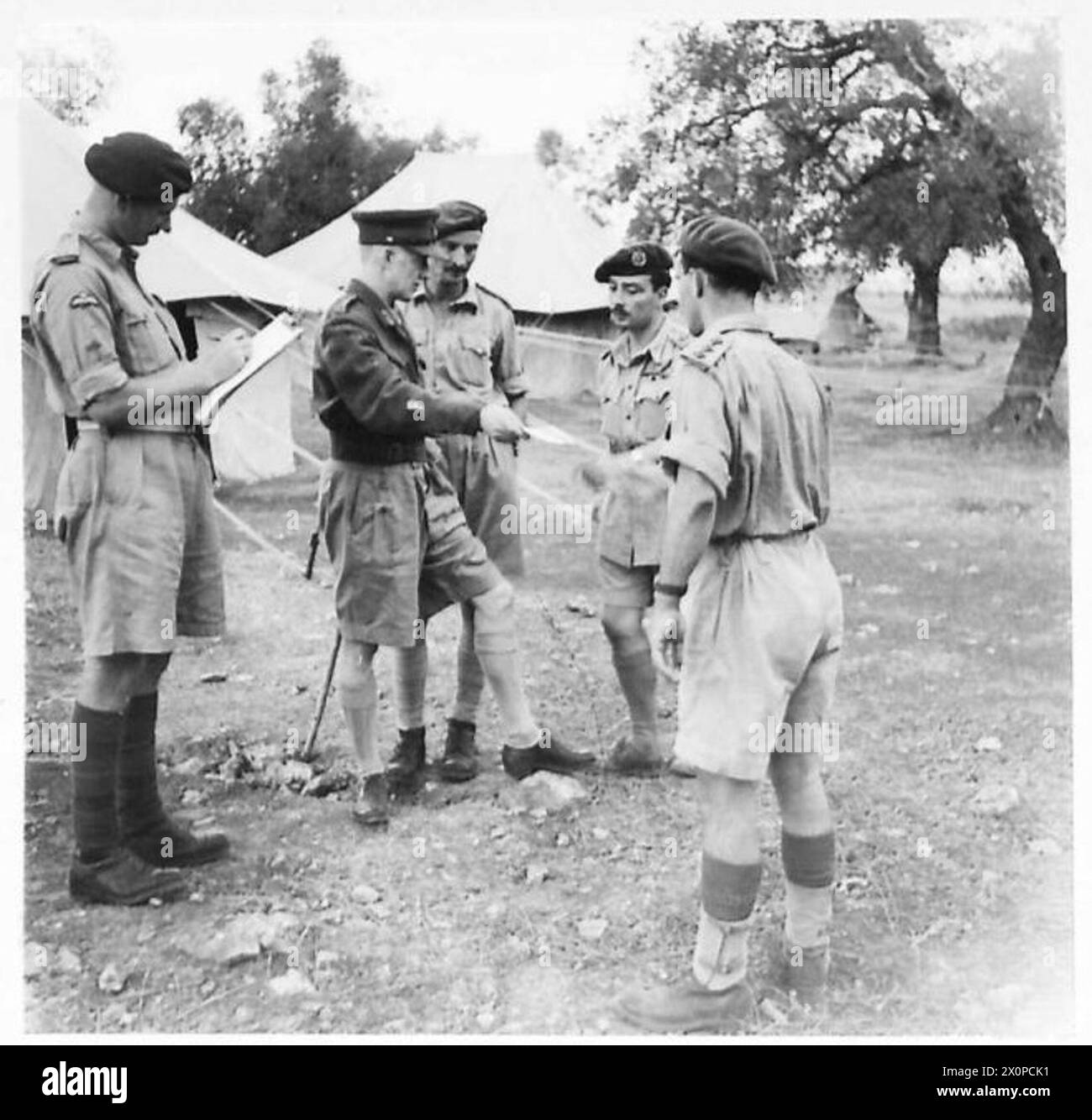 IL DIRETTORE DELL'AVIAZIONE VISITA LA FORMAZIONE AEREA BRITANNICA - il direttore dell'aviazione restituisce le fotografie scattate dai piloti di alianti durante l'invasione della Francia al capitano W. (Wally) Masson, M., DFM. Da sinistra a destra: Maggiore J.L. Williams Brigadiere Pritchard maggiore generale Crawford maggiore T.D.B. McMillen, MC., capitano W. Masson, M., DFM. Negativo fotografico, British Army Foto Stock