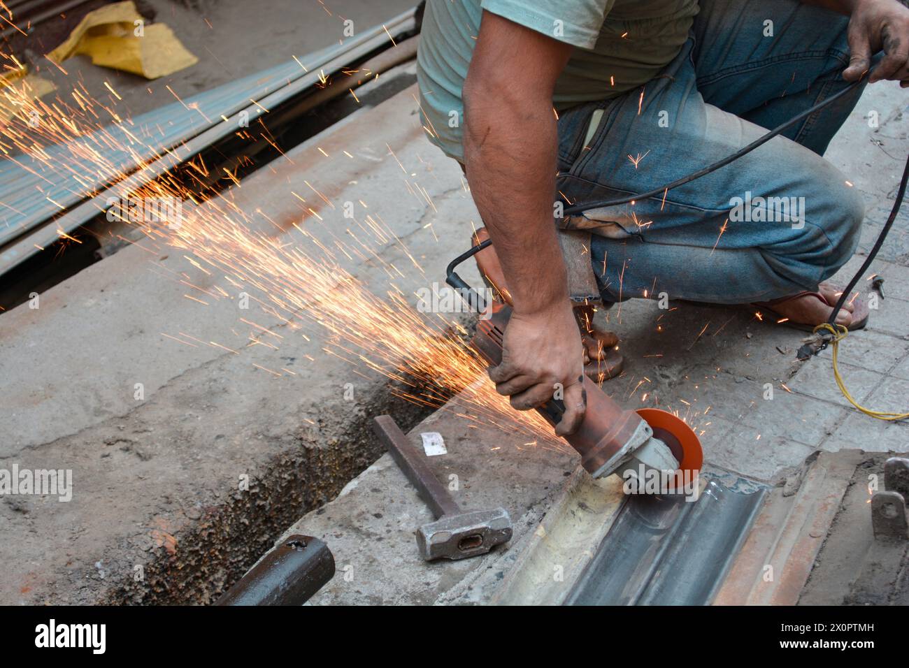 Uomo che taglia una striscia di otturatori in ferro galvanizzato Foto Stock