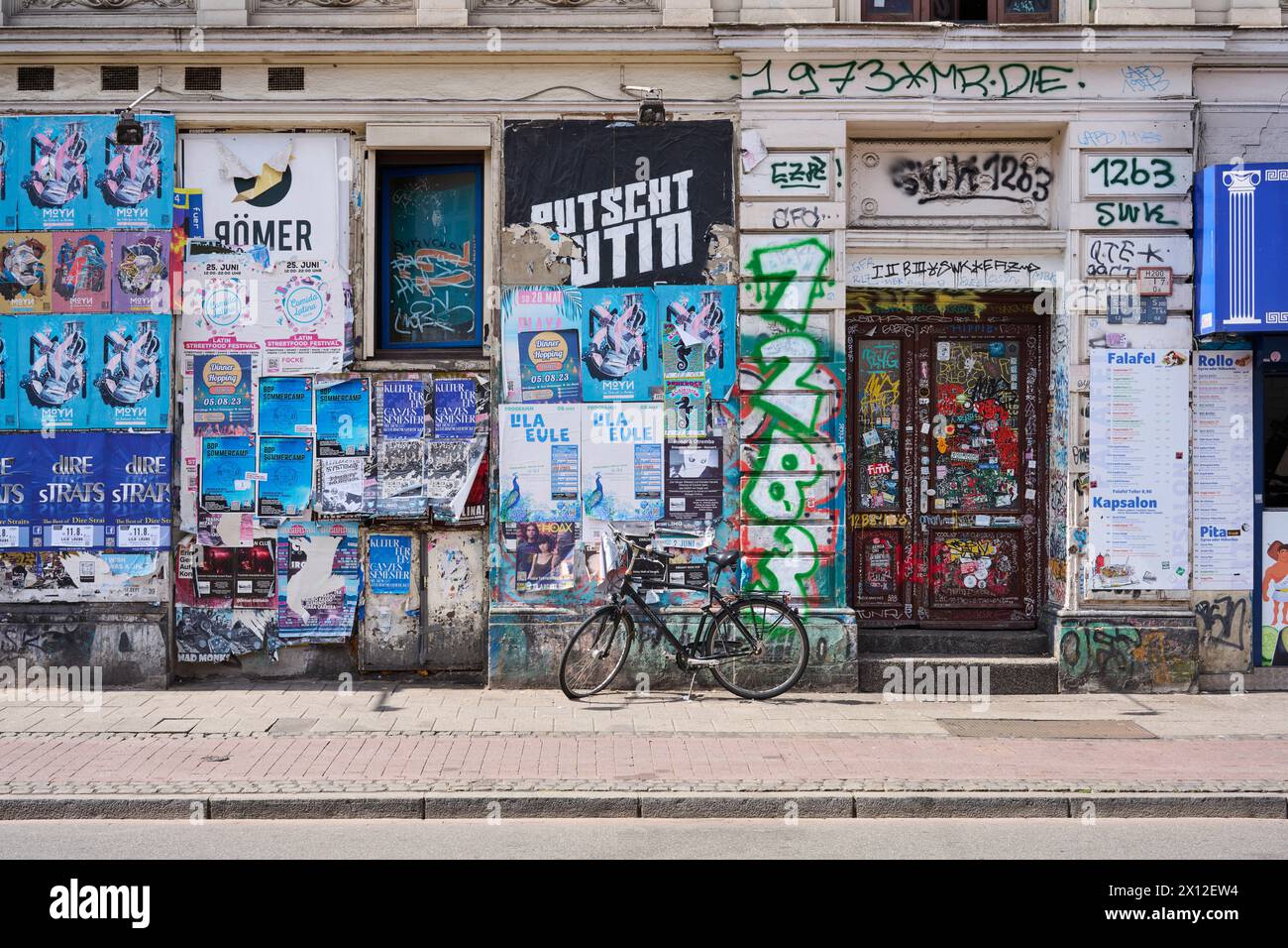 intensiv plakatierte und besprühte Wand im Bremer Ostertor-Kiez Foto Stock