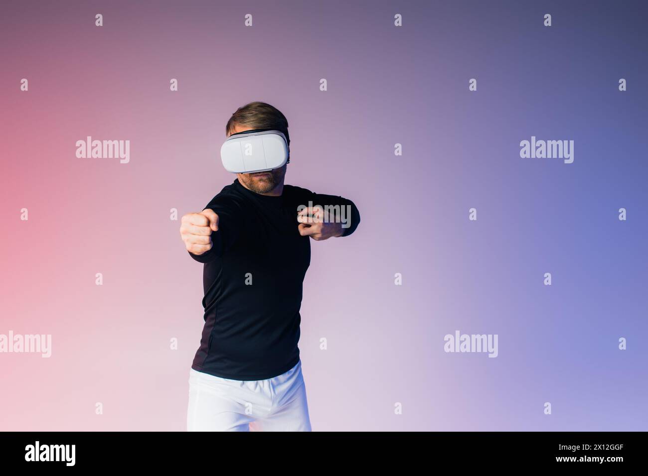 Un uomo, bendato, si erge davanti a un vibrante sfondo rosa e blu in un surreale ambiente da studio. Foto Stock