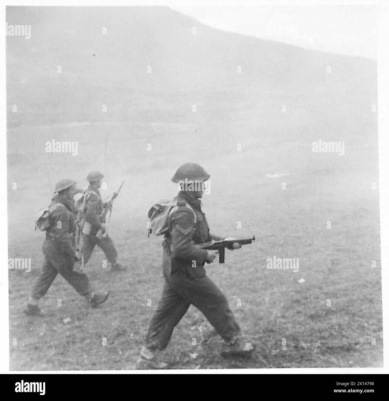 Le forze terrestri britanniche e neozelandesi avanzano attraverso una cortina di fumo durante un attacco a Cassino sul fronte della Quinta Armata in Italia. Foto Stock