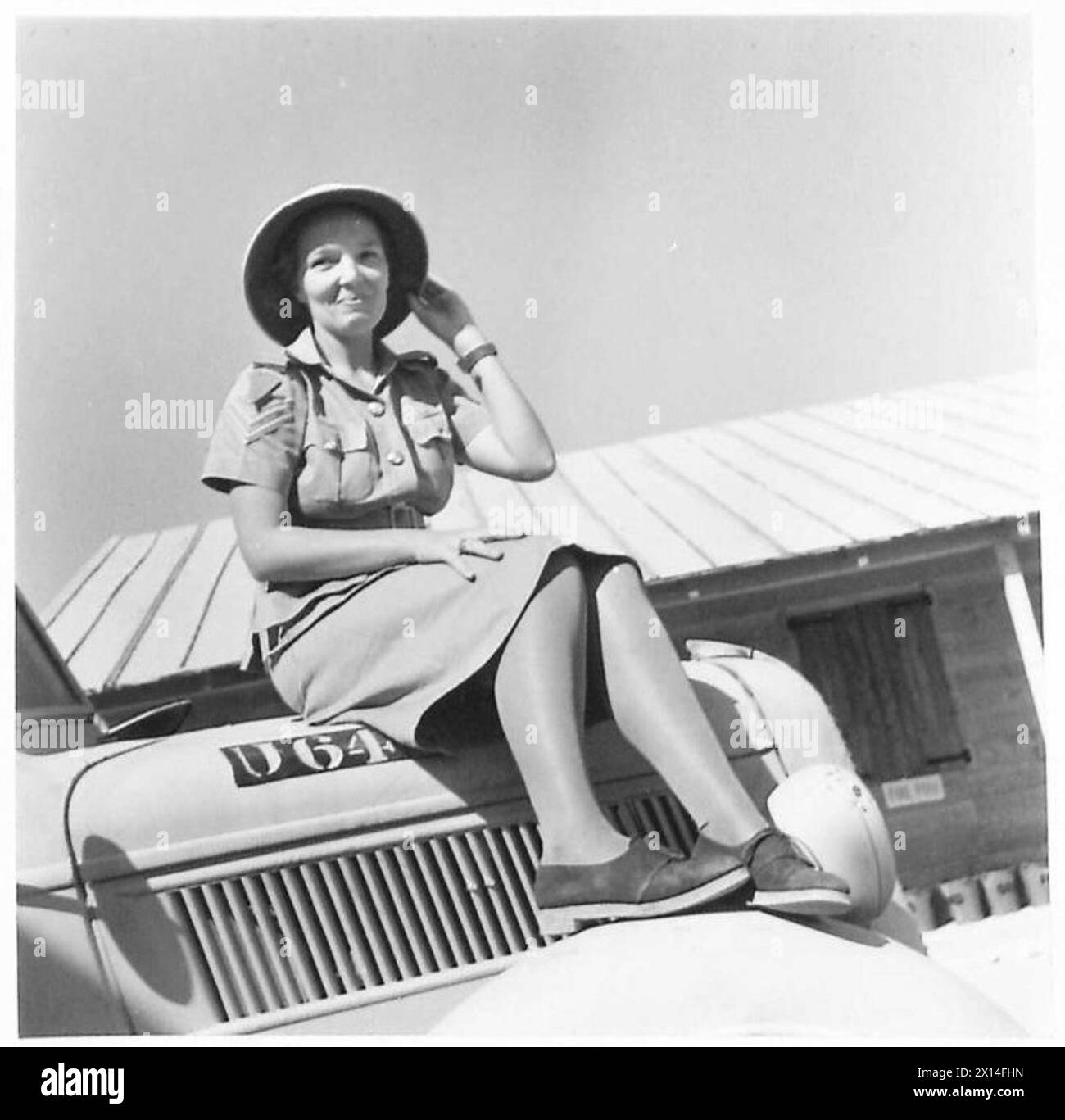 Il personale dei servizi ausiliari dell'esercito femminile gestisce il camion della razione in un campo nel deserto, illustrando il supporto logistico nelle operazioni sul campo. Foto Stock