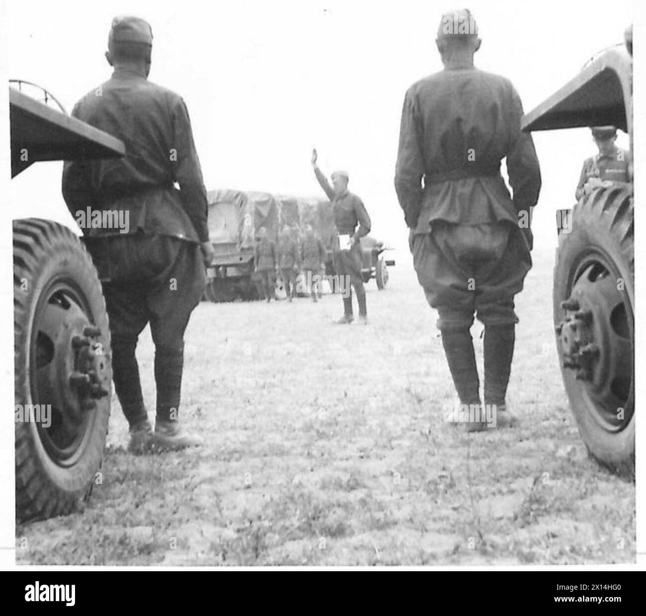 Un ufficiale russo dirige i conducenti di veicoli dell'esercito britannico quando vengono consegnati per il trasporto di rifornimenti verso la Russia. Foto Stock