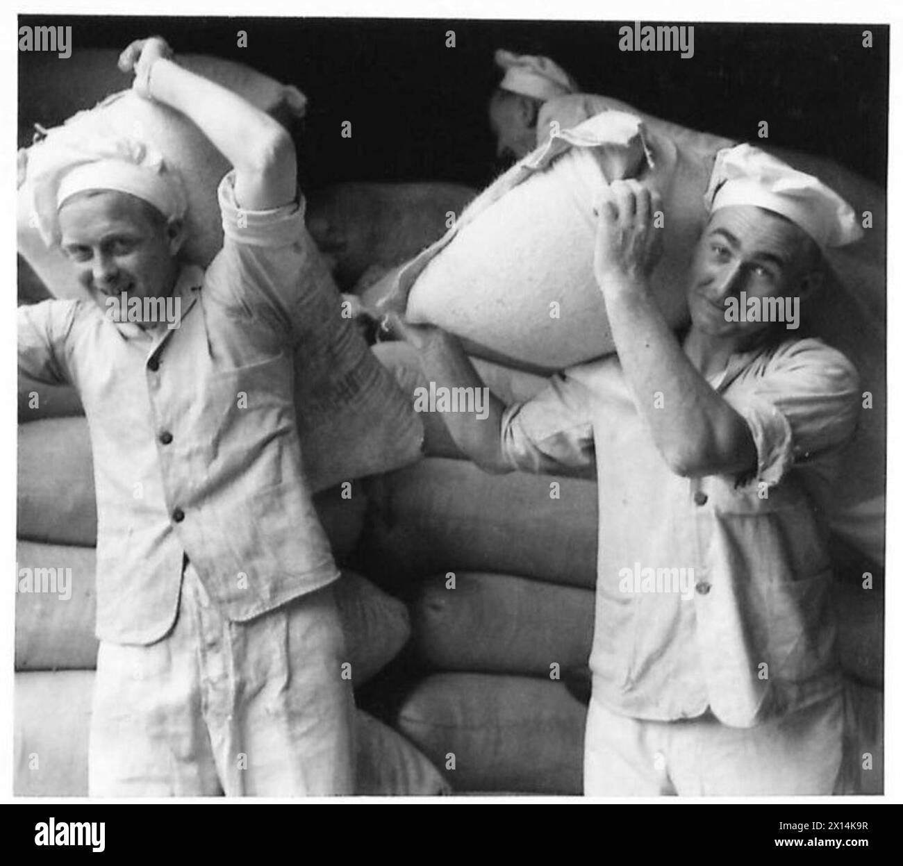 I sacchi di farina vengono rimossi dal deposito come parte delle operazioni di produzione del pane dell'esercito. Foto Stock