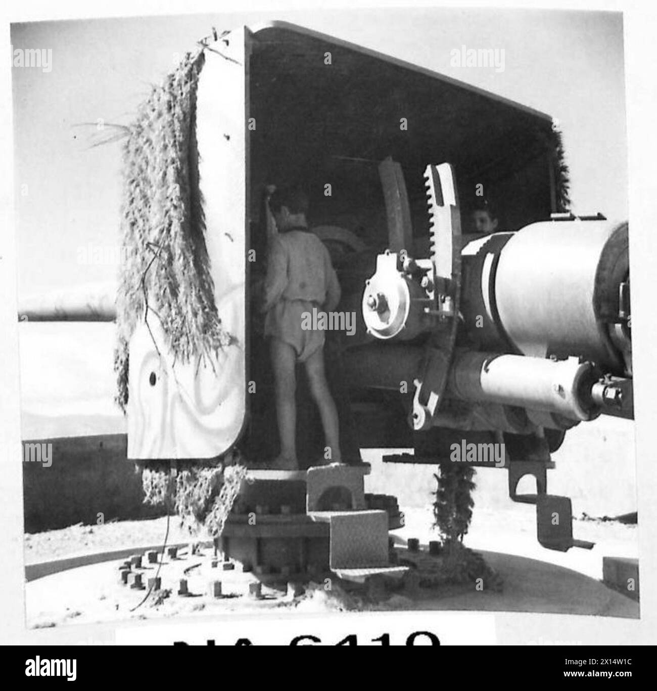 INVASIONE DELL'ITALIA - un bambino italiano che gioca intorno a un cannone costiero vicino a Pellaro, questo cannone (prodotto da Vickers, Inghilterra) 1930 che ancora punta verso la Sicilia, non ha sparato un colpo contro le nostre forze d'invasione British Army Foto Stock