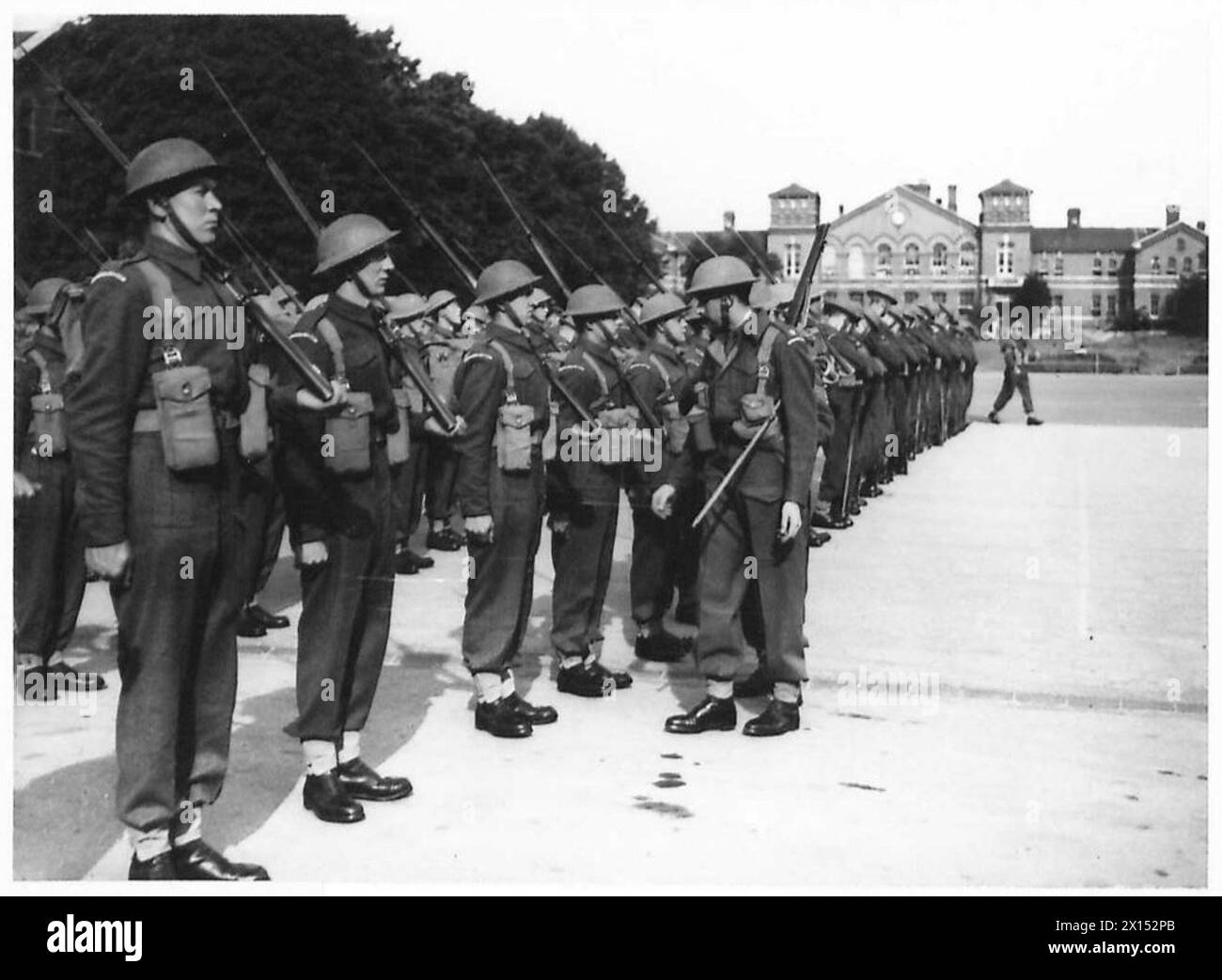 Al Castello di Windsor, gli ufficiali ispezionano le reclute del battaglione di addestramento Grenadier Guards sul campo da parata a Victoria Barracks. Foto Stock