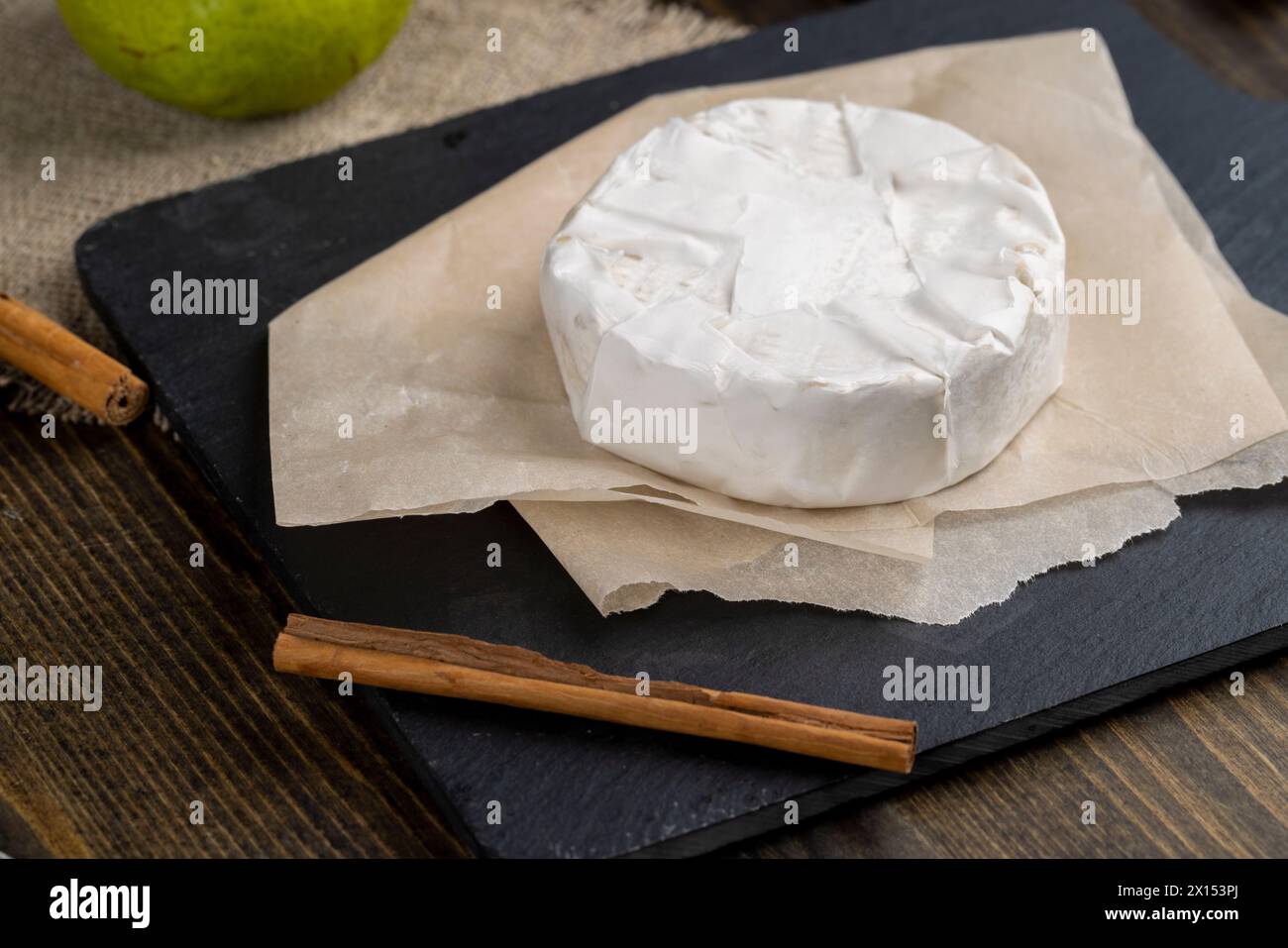 formaggio rotondo bianco con muffa sul tavolo, formaggio fresco morbido con muffa bianca nobile che si può mangiare Foto Stock