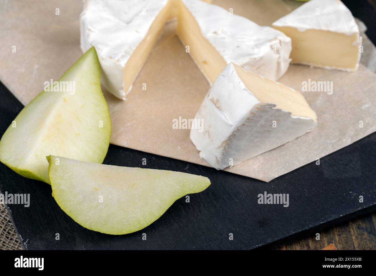 formaggio rotondo bianco con muffa sul tavolo, formaggio fresco morbido con muffa bianca nobile che si può mangiare Foto Stock