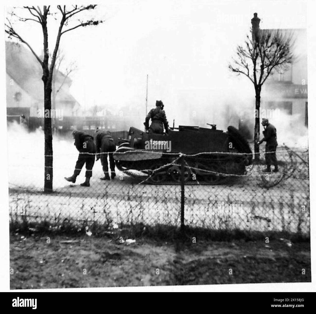I corrispondenti di guerra visitano l'Eastern Command, dove un veicolo corazzato nemico viene fermato da difese a filo spinato e bombe incendiarie sotto il controllo dell'esercito britannico. Foto Stock