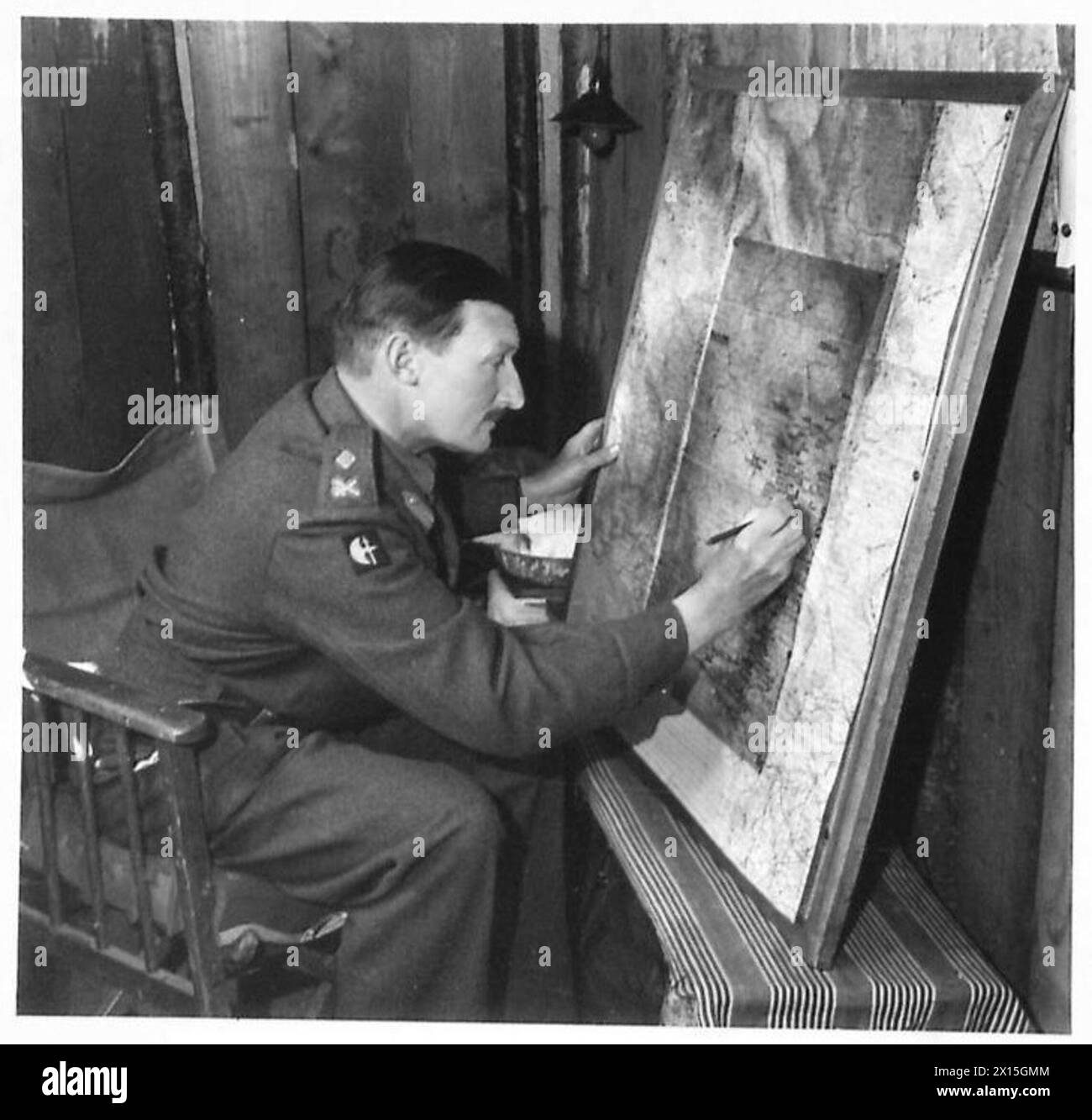 Il comandante della 78a divisione della Quinta armata studia le mappe che coprono le pareti di un scavato, illustrando la pianificazione operativa e le attività di comando. Foto Stock Il comandante della 78a divisione della Quinta armata studia le mappe che coprono le pareti di un scavato, illustrando la pianificazione operativa e le attività di comando. Foto Stock